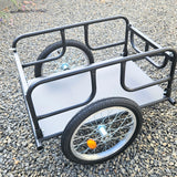 Bicycle cargo trailer with wheels on a gravel surface
