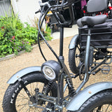 Close-up of a four-wheeled electric bike with visible branding on tires.