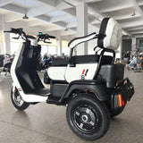 White and black electric scooter with a large seat in a showroom setting