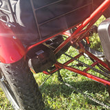 Close-up of a red ATV or similar vehicle on grass