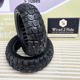 Two black rugged off-road tires stacked on a striped surface, with a Wired 2 Ride brand sign in the background.   Tyre 10*2.70-6.5

SOLID


rim 160mm

inner 147mm

inner diameter 53mm