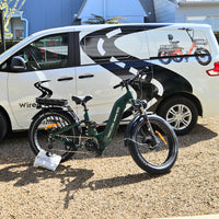 Electric bike parked in front of a white van with branding on the side.